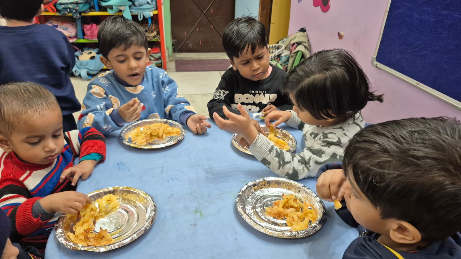Young children enjoying their meals